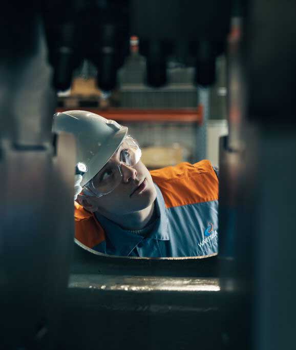 Engineer looking inside engine