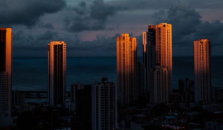 Cityscape as dusk falls. Skyscrapers with the last rays of the setting sun falling on them.