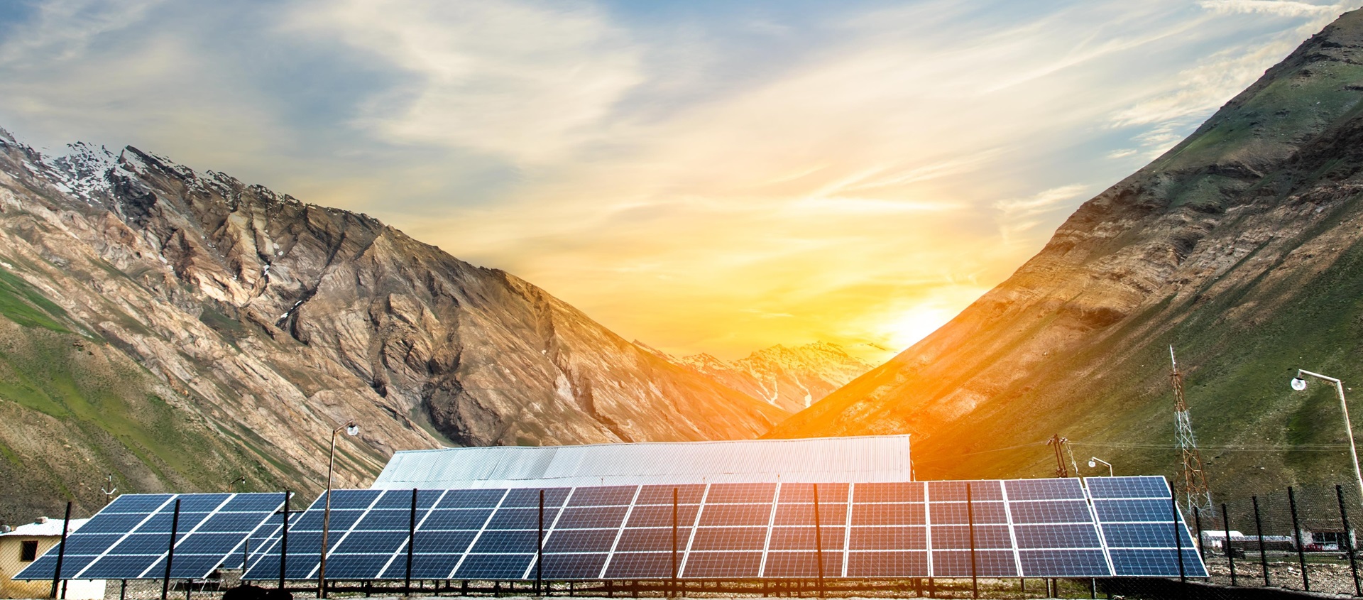 Power plant using renewable solar energy with sunset over the Gap in the Himalayan Mountain, Kashmir, India