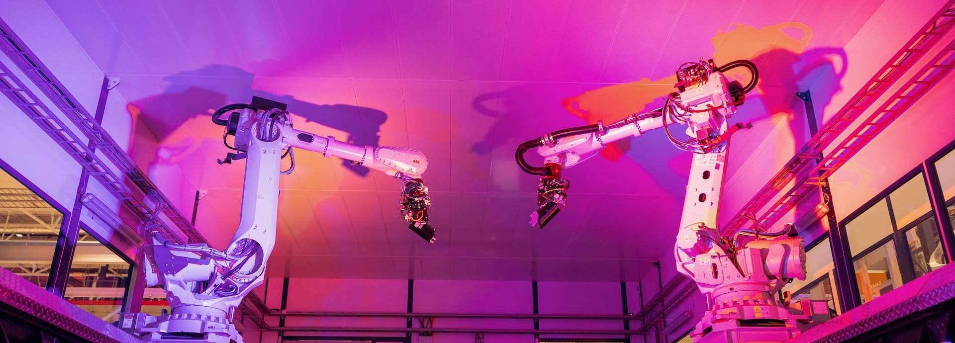 Manufacturing robotics on a pink background