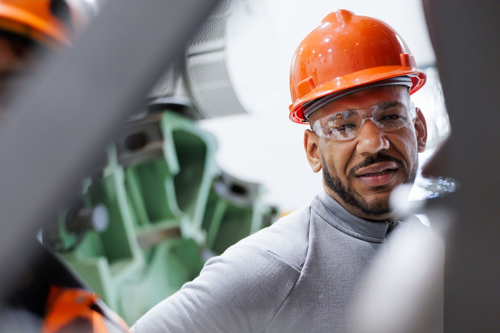 Wärtsilä Field Service Engineer Working in the USA Wärtsilä field service engineer in the US wearing a safety helmet and glasses while working on engine equipment.