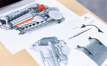 paper sheets with 3D illustration of a Wärtsilä engine on a table