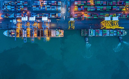Container ships lie at the quay in the port