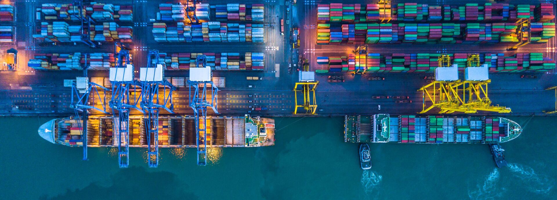 Container ships lie at the quay in the port
