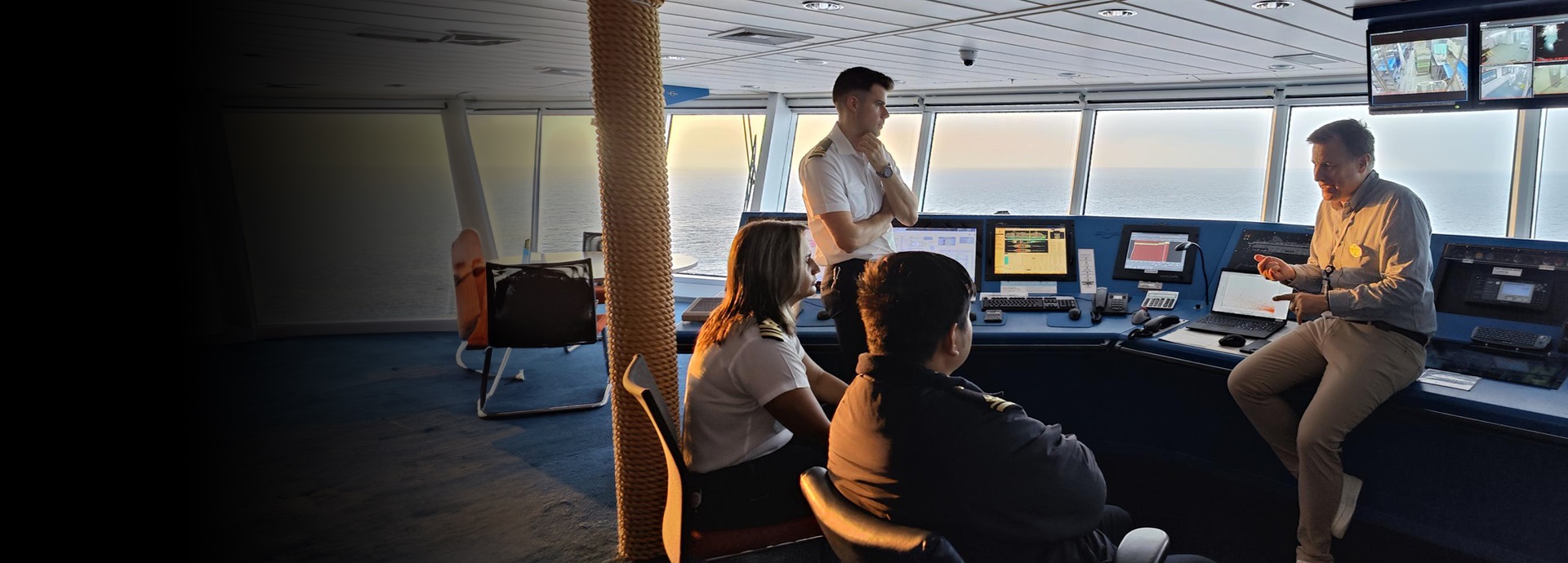 Group of people in front of a ship bridge