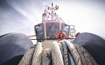 tugboat worker standing on bridge