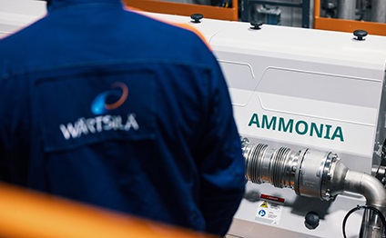 Wärtsilä employee in front of an engine running with Ammonia