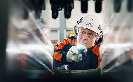 Wärtsilä employee looks inside the engine