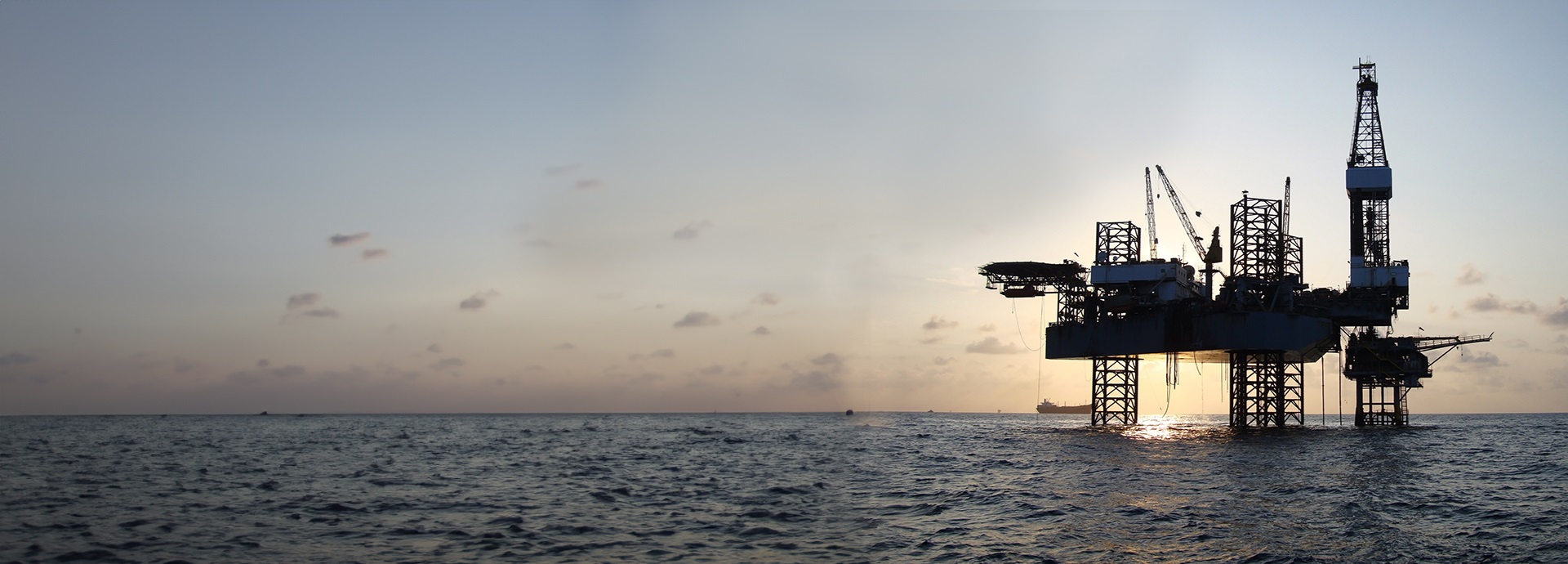 Offshore Jack Up Rig in The Middle of The Sea at Sunset Time