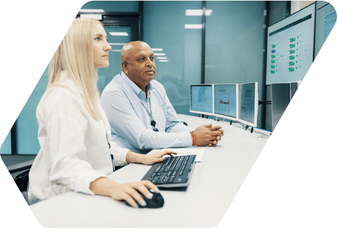Two people sitting in front of a computer
