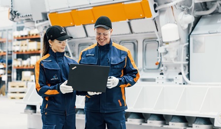 Two field engineers looking at a laptop