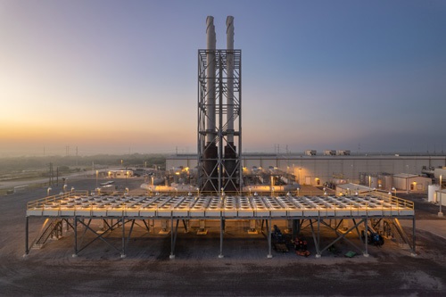 View of power plant at sunset.