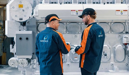 Engineers next to engine