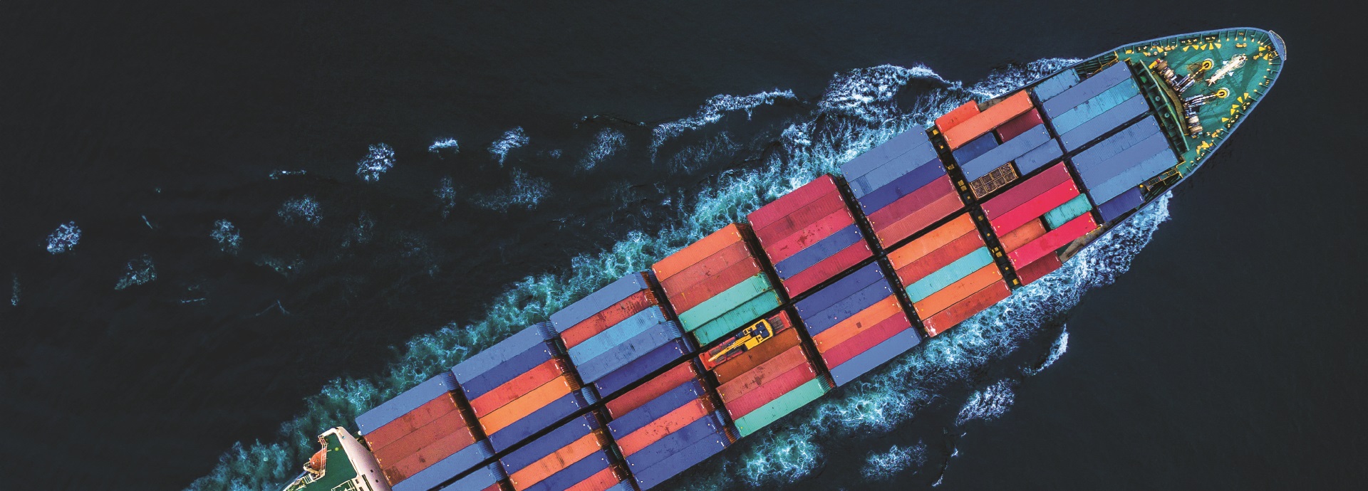 The bow of a container ship from a bird's-eye view.