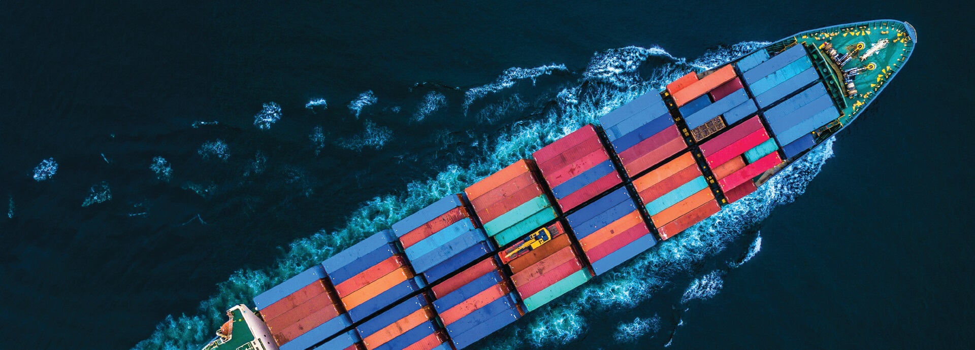 The bow of a container ship from a bird's-eye view.