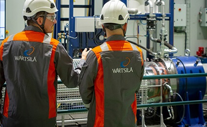 Wärtsilä Service employees in front of a shaft