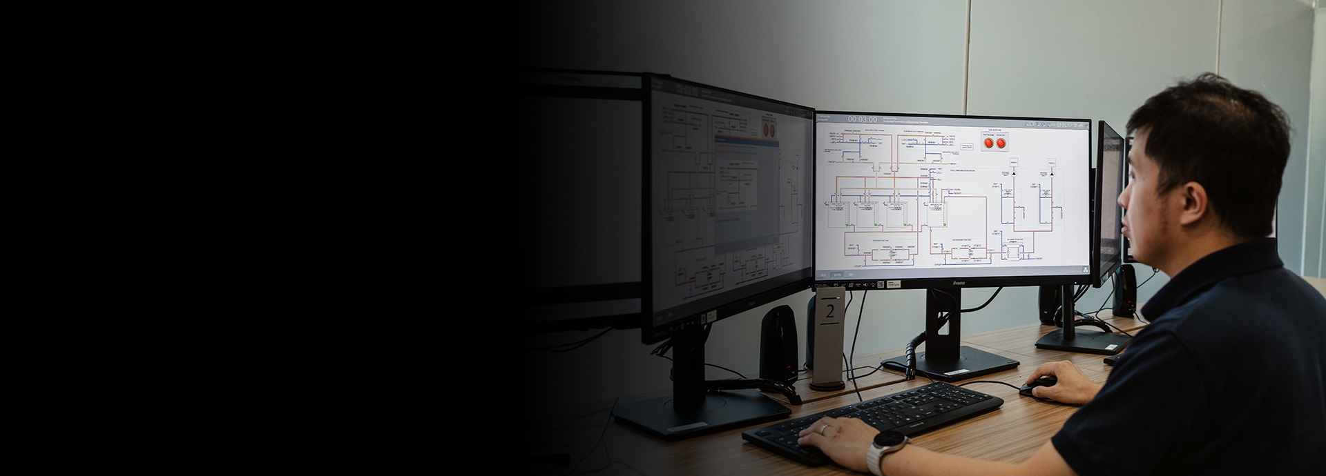 man sits in front of simulator monitors