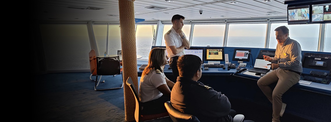 Group of people on a ship's bridge
