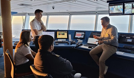 Group of people on a ship's bridge