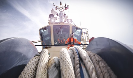 tugboat worker standing on bridge