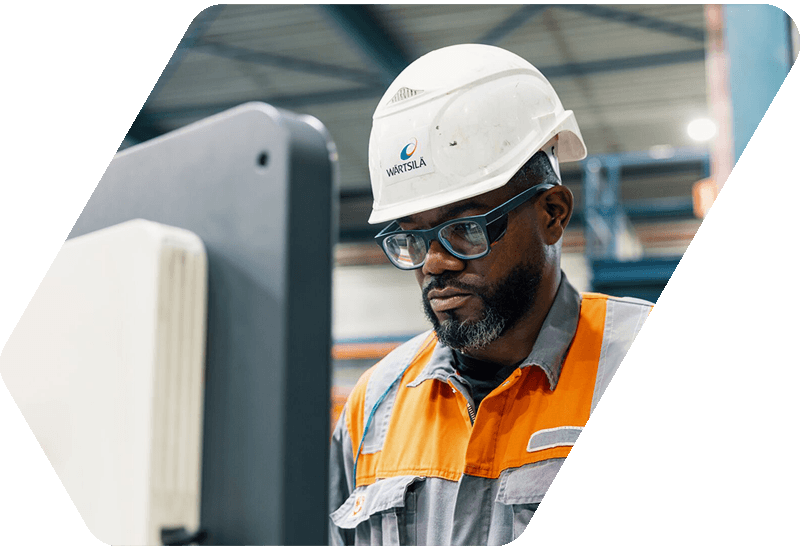 Wärtsilä service employee sitting in front of a monitor