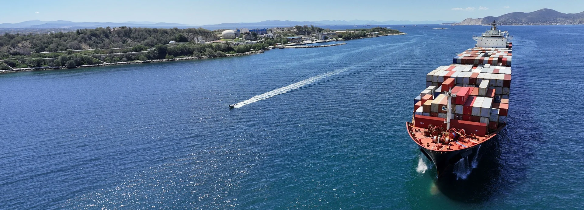 container ship carrying containers in deep blue sea near Mediterranean terminal port