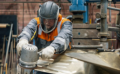 Service employee works on propeller