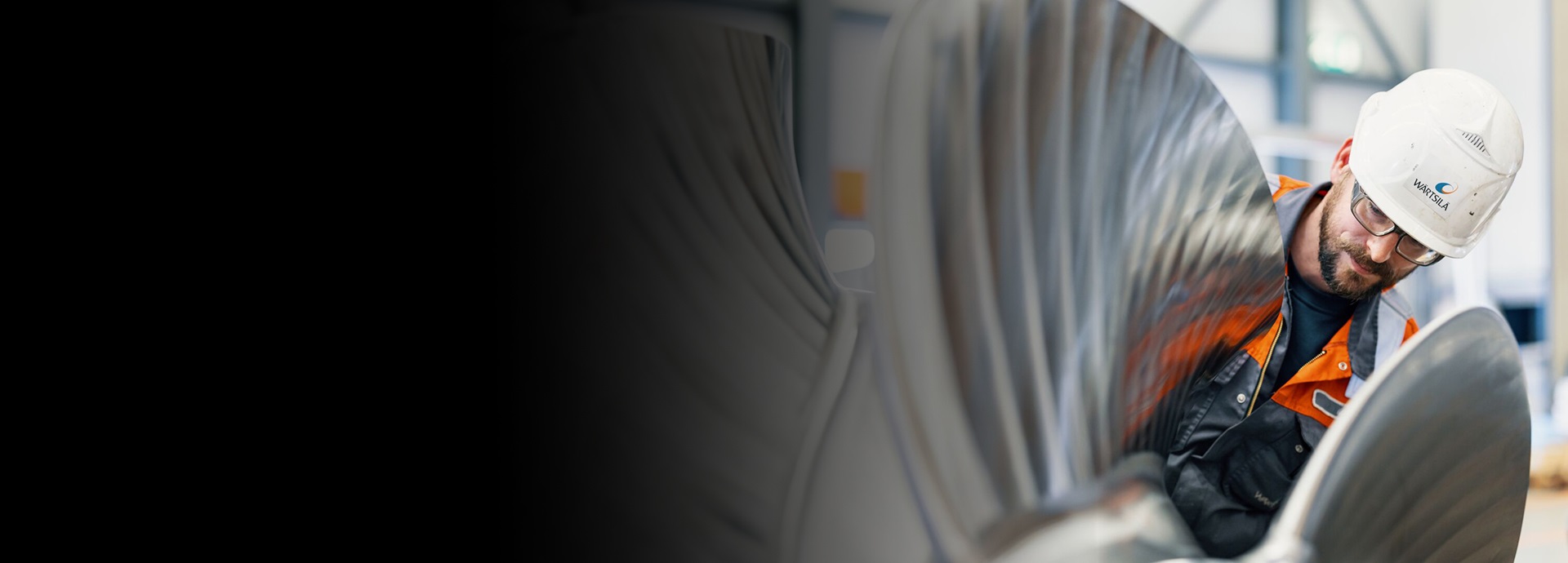 Service employee in the workshop is working on a propeller