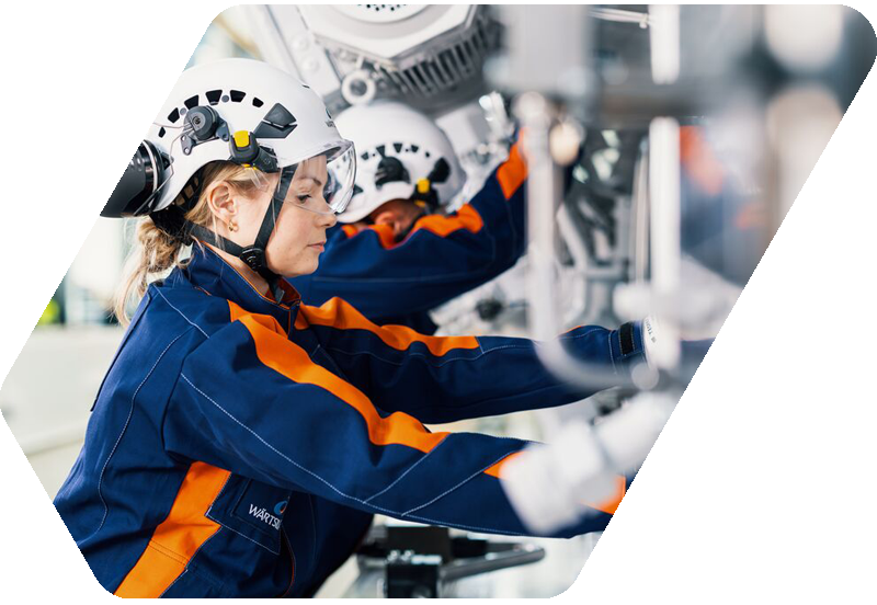 Service employees working on an engine