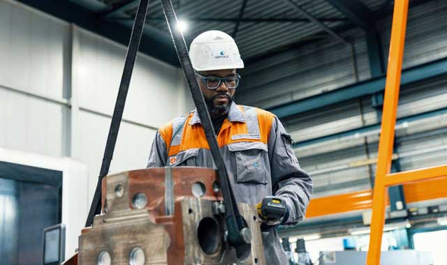 A service engineer lifting a block