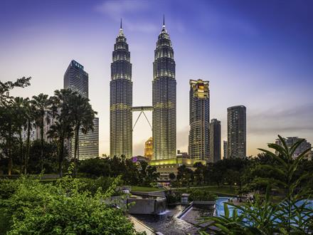 Kuala Lumpur KLCC Park Petronas Towers illuminated at sunset Malaysia