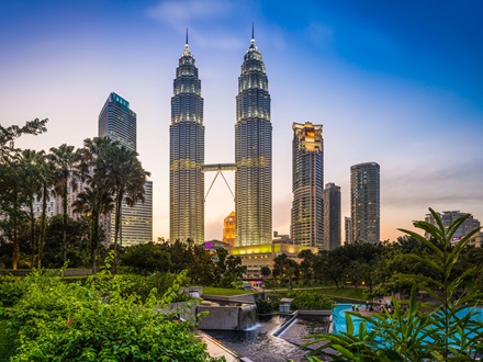 Kuala Lumpur KLCC Park Petronas Towers illuminated at sunset Malaysia