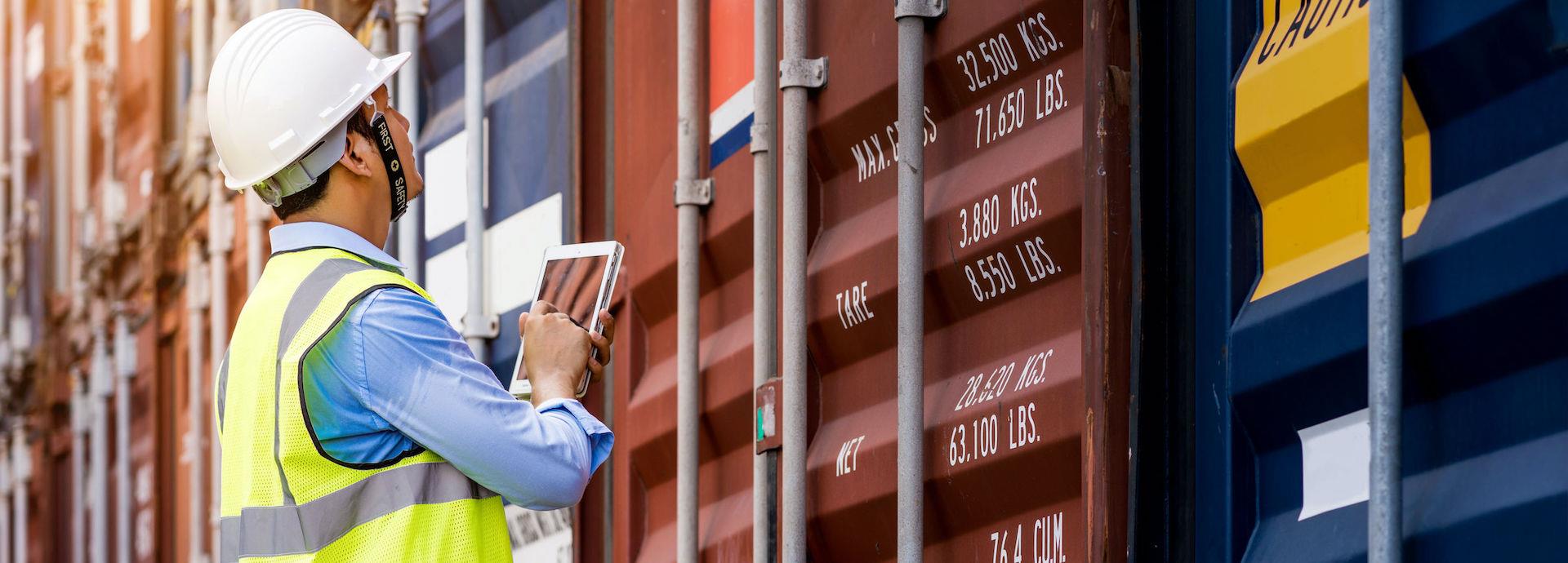 Workman tracking shipping containers