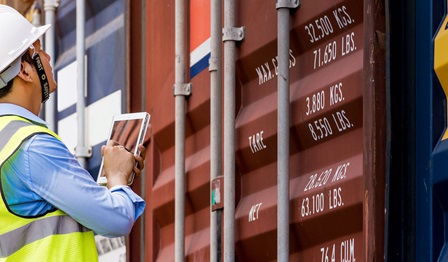 Workman tracking shipping containers